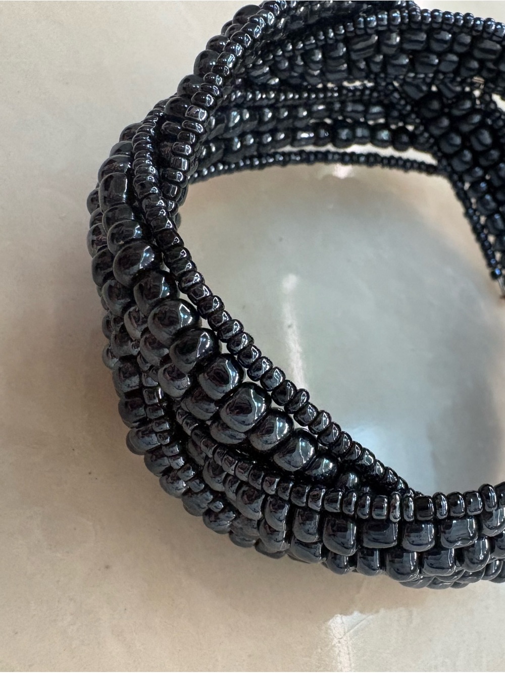 Multi-strand braided black seed bead memory wire cuff bracelet